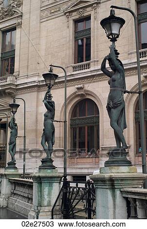 Stock Image - Staute lampposts at the Palace Garnier in Paris France. Fotosearch