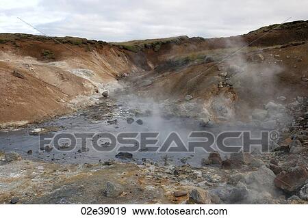 Steam rising from rocky geothermal pool View Large Photo Image Stock Photo - Steam rising from rocky geothermal pool. Fotosearch