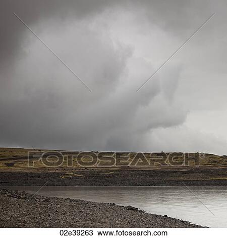 Storm cloud over barren coastline of Jokullsarlon lagoon View Large Photo Image Stock Image - Storm cloud over barren coastline of Jokullsarlon lagoon. Fotosearch