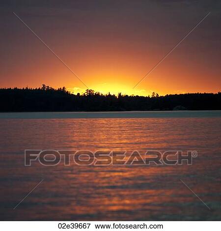 Stock Photo - Sunset at Lake of the Woods, Ontario. Fotosearch