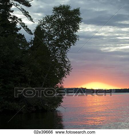 Stock Photograph - Sunset at Lake of the Woods, Ontario. Fotosearch