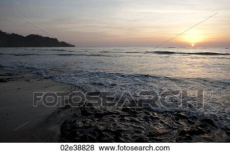 Sunset over the beach at Costa Rica with cool overtones View Large Photo Image Stock Photo - Sunset over the beach at Costa Rica with cool overtones. Fotosearch
