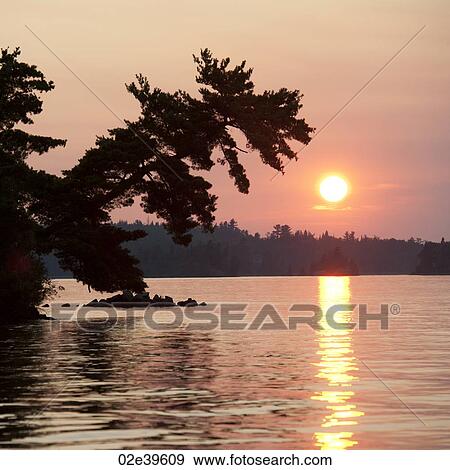 Stock Photo - Sunset sky at Lake of the Woods, Ontario. Fotosearch
