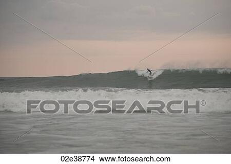 Surfer along Mal Pais coastline in San Jose Costa Rica View Large Photo Image Picture - Surfer along Mal Pais coastline in San Jose Costa Rica. Fotosearch
