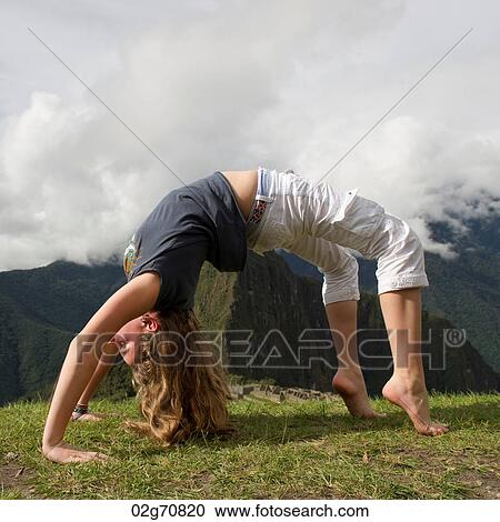 Teenage girl doing wheel pose with valley in the background, The Lost City of The Incas, Machu Picchu, Cusco Region, Peru View Large Photo Image Stock Image - Teenage girl doing wheel pose with valley in the background, The Lost City of The Incas, Machu Picchu, Cusco Region, Peru. Fotosearch