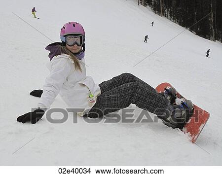 Teenage girl sitting on a ski hill with a snow boad in Vail, Colorado View Large Photo Image Picture - Teenage girl sitting on a ski hill with a snow boad in Vail, Colorado. Fotosearch