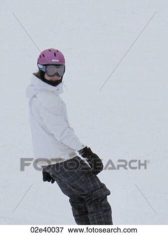 Teenage girl snowboarding on a ski slope in Vail, Colorado View Large Photo Image Stock Photo - Teenage girl snowboarding on a ski slope in Vail, Colorado . Fotosearch