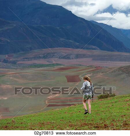 Teenage girl walking in a field with Sacred Valley in the background, Cusco Region, Peru View Large Photo Image Stock Image - Teenage girl walking in a field with Sacred Valley in the background, Cusco Region, Peru. Fotosearch
