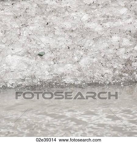 Thawing ice crystals at water's edge View Large Photo Image Picture - Thawing ice crystals at water's edge. Fotosearch