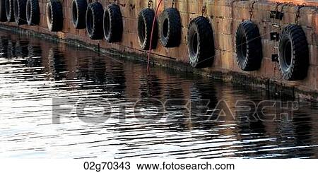 Tires hanging on a jetty, Stranden, Oslo, Norway View Large Photo Image Stock Image - Tires hanging on a jetty, Stranden, Oslo, Norway. Fotosearch