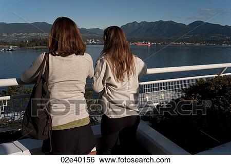Tourists looking at shoreline in Vancouver, British Columbia, Canada View Large Photo Image Stock Photograph - Tourists looking at shoreline in Vancouver, British Columbia, Canada. Fotosearch
