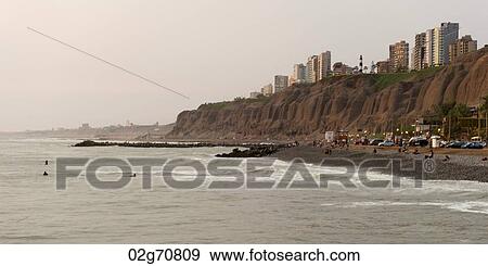 Tourists on the beach with a city in the background, Miraflores District, Lima Province, Peru View Large Photo Image Stock Photo - Tourists on the beach with a city in the background, Miraflores District, Lima Province, Peru. Fotosearch