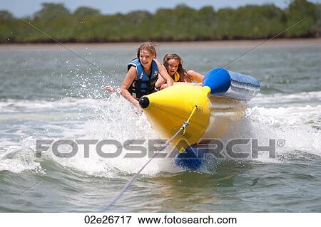 Two girls on watercraft at Manda Bay Resort Kenya Africa View Large Photo Image Stock Photo - Two girls on watercraft at Manda Bay Resort Kenya Africa. Fotosearch