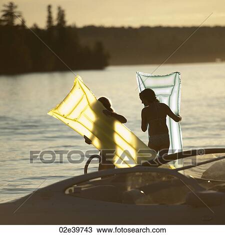 Two girls with float mattresses at Lake of the Woods, Ontario View Large Photo Image Stock Image - Two girls with float mattresses at Lake of the Woods, Ontario. Fotosearch