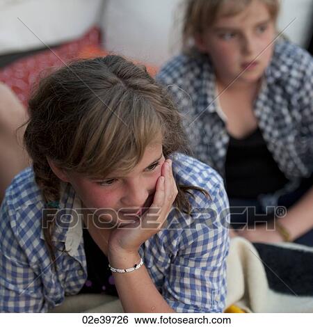 Two young girls looking off into the distance View Large Photo Image Stock Photograph - Two young girls looking off into the distance. Fotosearch