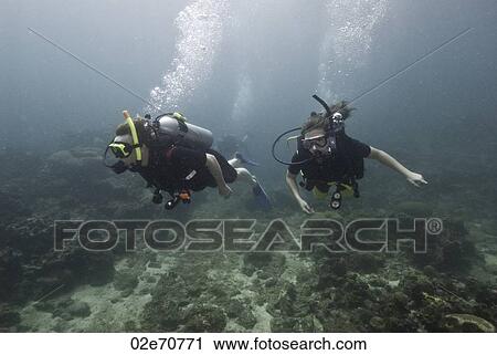 Stock Image - Underwater scene with scuba divers. Fotosearch