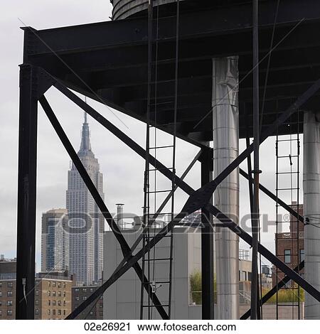 Stock Image - View of the Empire State Building from Chelsea district in Manhattan, New York City, U. S. A.. Fotosearch
