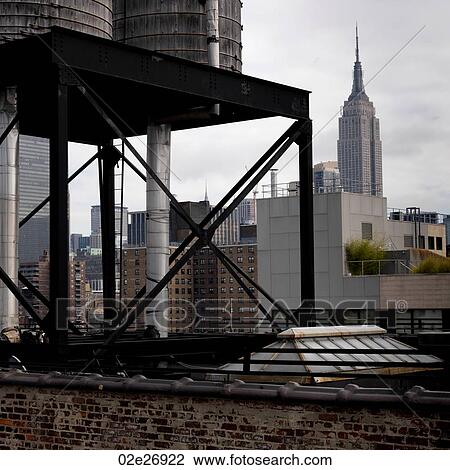 Stock Image - View of the Empire State Building from Chelsea district in Manhattan, New York City, U. S. A.. Fotosearch