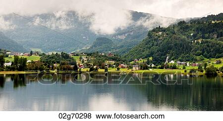 Village at waterfront, Hardanger, Hardangerfjord, Hardangervidda, Hardanger, Norway View Large Photo Image Stock Photo - Village at waterfront, Hardanger, Hardangerfjord, Hardangervidda, Hardanger, Norway. Fotosearch