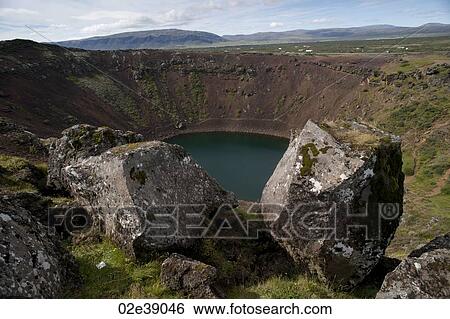 Volcanic crater lake with moss and lichen covered boulders View Large Photo Image Stock Photograph - Volcanic crater lake with moss and lichen covered boulders . Fotosearch