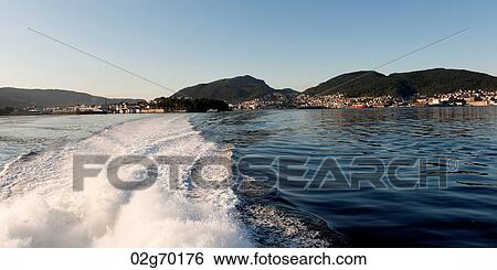 Wake from a moving boat with Bergen town in the background, Norway View Large Photo Image Stock Photograph - Wake from a moving boat with Bergen town in the background, Norway. Fotosearch