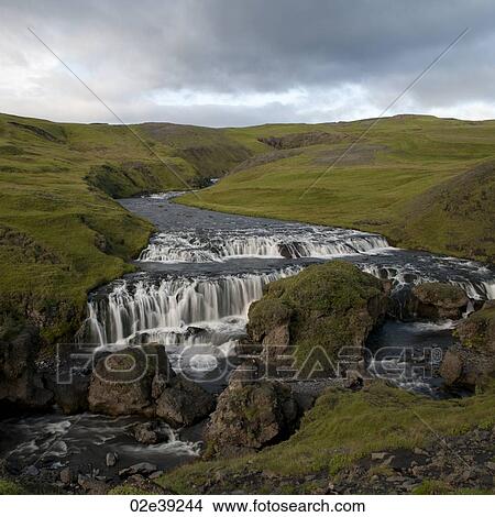 Waterfall cascade in verdant grassland View Large Photo Image Picture - Waterfall cascade in verdant grassland. Fotosearch