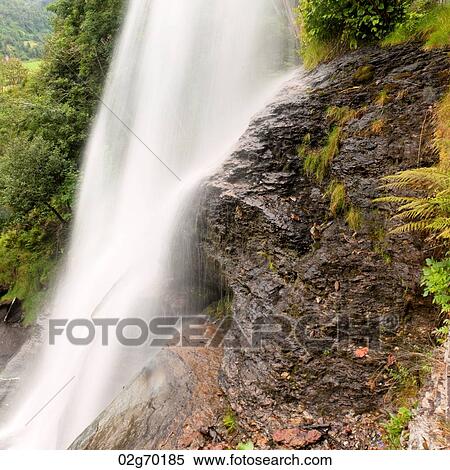 Stock Photography - Waterfall in a forest, Steinsdalsfossen, Norheimsund, Hardangervidda, Hardanger, Norway. Fotosearch