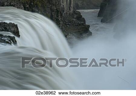 Waterfall through rugged terrain of rock and boulders View Large Photo Image Stock Image - Waterfall through rugged terrain of rock and boulders. Fotosearch