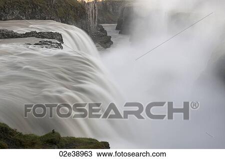 Waterfall through rugged terrain of rock and boulders View Large Photo Image Stock Image - Waterfall through rugged terrain of rock and boulders. Fotosearch