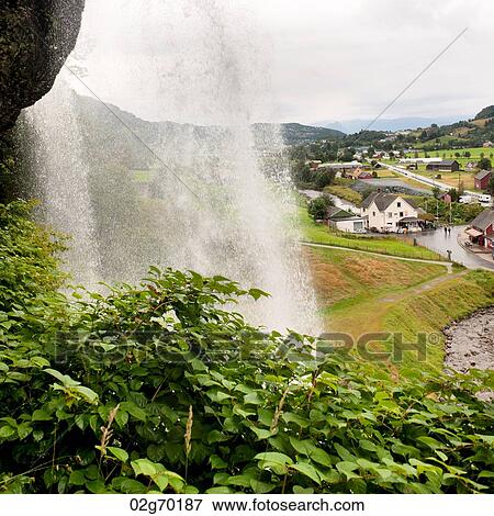 Waterfall with a village in the background, Steinsdalsfossen, Norheimsund, Hardangervidda, Hardanger, Norway View Large Photo Image Stock Photo - Waterfall with a village in the background, Steinsdalsfossen, Norheimsund, Hardangervidda, Hardanger, Norway. Fotosearch