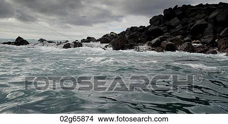 Waves breaking on the coast, Playa Ochoa, San Cristobal Island, Galapagos Islands, Ecuador View Large Photo Image Picture - Waves breaking on the coast, Playa Ochoa, San Cristobal Island, Galapagos Islands, Ecuador. Fotosearch