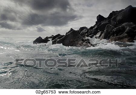 Waves breaking on the coast, Playa Ochoa, San Cristobal Island, Galapagos Islands, Ecuador View Large Photo Image Stock Image - Waves breaking on the coast, Playa Ochoa, San Cristobal Island, Galapagos Islands, Ecuador. Fotosearch