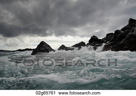 Stock Image - Waves breaking on the coast, Playa Ochoa, San Cristobal Island, Galapagos Islands, Ecuador. Fotosearch