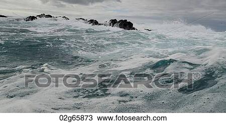 Stock Image - Waves breaking on the coast, Playa Ochoa, San Cristobal Island, Galapagos Islands, Ecuador. Fotosearch