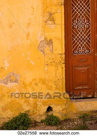Stock Photo - Weathered yellow wall in Rhodes Greece. Fotosearch