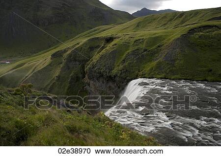 White water flowing over a cliff surrounded by green meadows in the mountains View Large Photo Image Stock Image - White water flowing over a cliff surrounded by green meadows in the mountains. Fotosearch