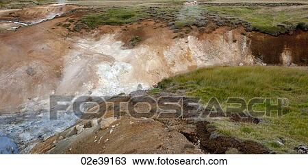 Stock Image - White water river gorge cut into grassland. Fotosearch
