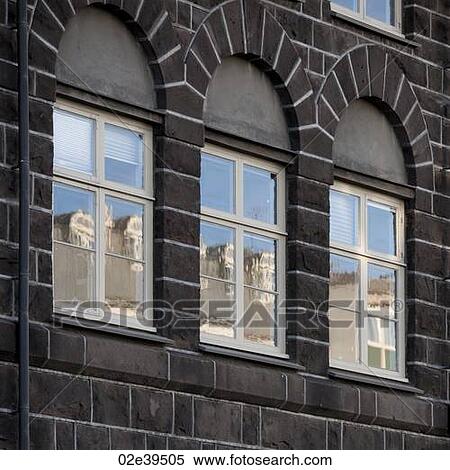 Windows in brick building reflecting buildings opposite View Large Photo Image Stock Photography - Windows in brick building reflecting buildings opposite. Fotosearch