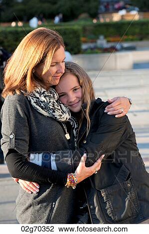 Woman hugging her daughter, Oslo, Norway View Large Photo Image Stock Image - Woman hugging her daughter, Oslo, Norway. Fotosearch