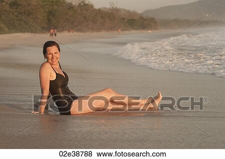 Woman on beach along Mal Pais coastline in San Jose Costa Rica View Large Photo Image Stock Photo - Woman on beach along Mal Pais coastline in San Jose Costa Rica. Fotosearch