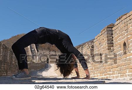 Woman practicing yoga at the Mutianyu section of the Great Wall of China, Beijing, China View Large Photo Image Stock Image - Woman practicing yoga at the Mutianyu section of the Great Wall of China, Beijing, China. Fotosearch
