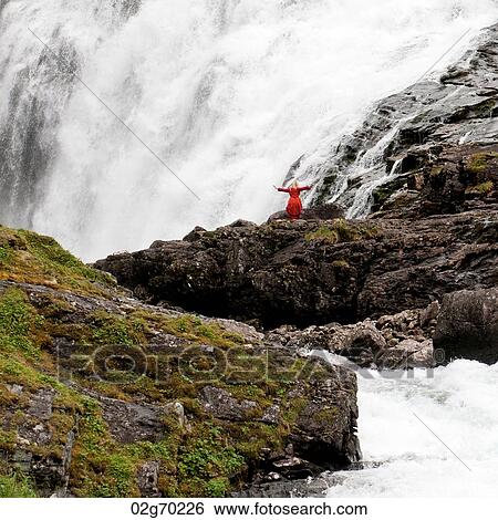 Woman standing near a waterfall, Kjosfossen, Aurland, Fjordane County, Norway View Large Photo Image Stock Photograph - Woman standing near a waterfall, Kjosfossen, Aurland, Fjordane County, Norway. Fotosearch
