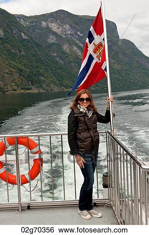 Woman standing on cruise ship deck, Norway View Large Photo Image Stock Photograph - Woman standing on cruise ship deck, Norway. Fotosearch
