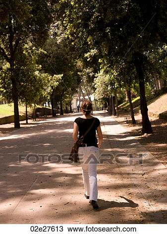 Woman walking in a park in Rome Italy View Large Photo Image Stock Image - Woman walking in a park in Rome Italy. Fotosearch