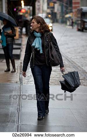 Woman walking in Manhattan, New York City, U. S. A. View Large Photo Image Picture - Woman walking in Manhattan, New York City, U. S. A.. Fotosearch