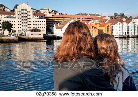Woman with her daughter on boat and looking at city, Bergen, Norway View Large Photo Image Stock Photo - Woman with her daughter on boat and looking at city, Bergen, Norway. Fotosearch
