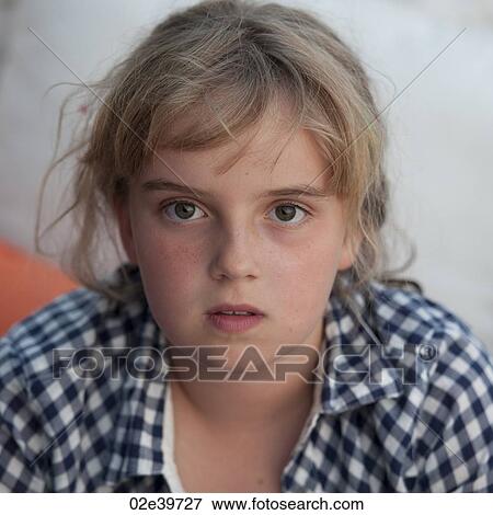 Stock Photo - Young blond girl looking at the camera. Fotosearch