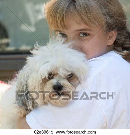 Young girl cuddling her dog at Lake of the Woods, Ontario View Large Photo Image Stock Photography - Young girl cuddling her dog at Lake of the Woods, Ontario. Fotosearch