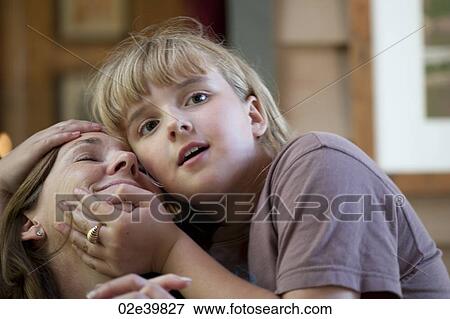 Young girl embracing her Mother View Large Photo Image Stock Photo - Young girl embracing her Mother. Fotosearch