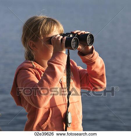 Young girl looking through binoculars at Lake of the Woods, Ontario View Large Photo Image Stock Photograph - Young girl looking through binoculars at Lake of the Woods, Ontario. Fotosearch